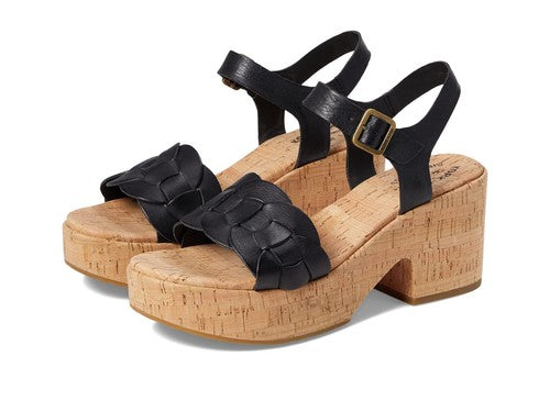 Black strappy sandals with cork platforms on a white background
