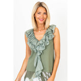 Woman wearing a green ruffled top on a white background