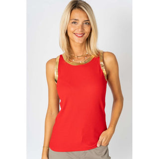 Woman wearing a red sleeveless top with gold trim on a plain background