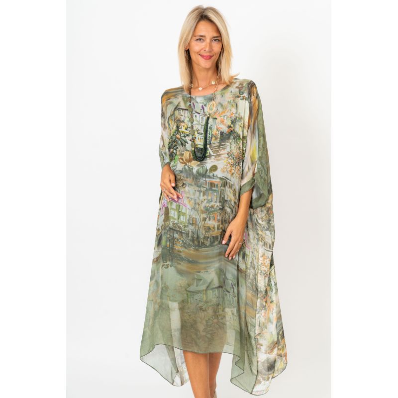 Woman wearing a floral dress with a sheer overlay on a white background