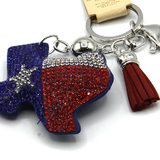 Keychain with Texas-shaped design, red and blue colors, and tassel on a white background.