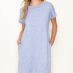 Woman wearing a light blue dress against a white background