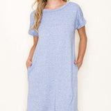 Woman wearing a light blue dress against a white background
