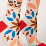 Colorful socks with geometric patterns and text on a white background