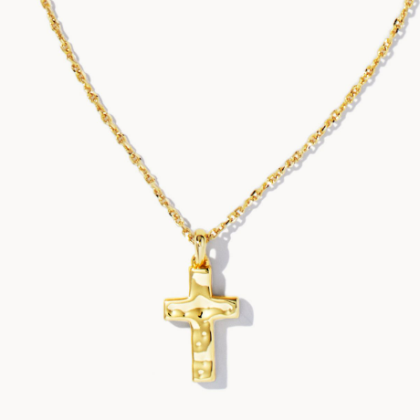 Gold cross pendant on a gold chain against a white background