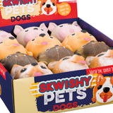 A box of Skwishy Pets Dogs toys, featuring a variety of plush dog figures in different colors.