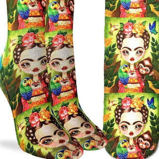 Colorful socks with a design of a woman, parrots, and flowers on a green background.