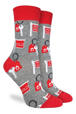 Gray socks with red accents featuring real estate-themed designs on a white background